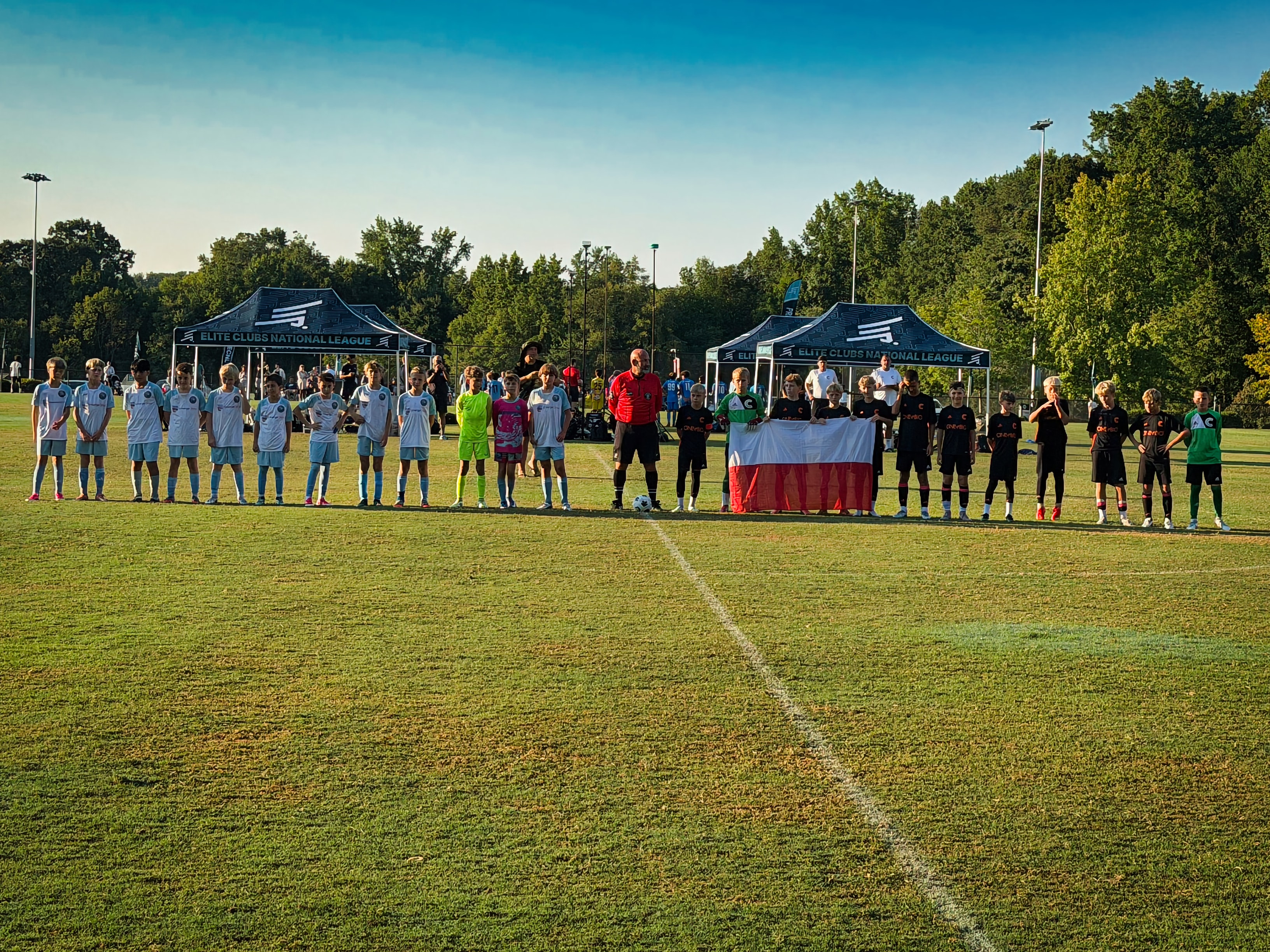 Teams lined up with flag at ECNL tournament
