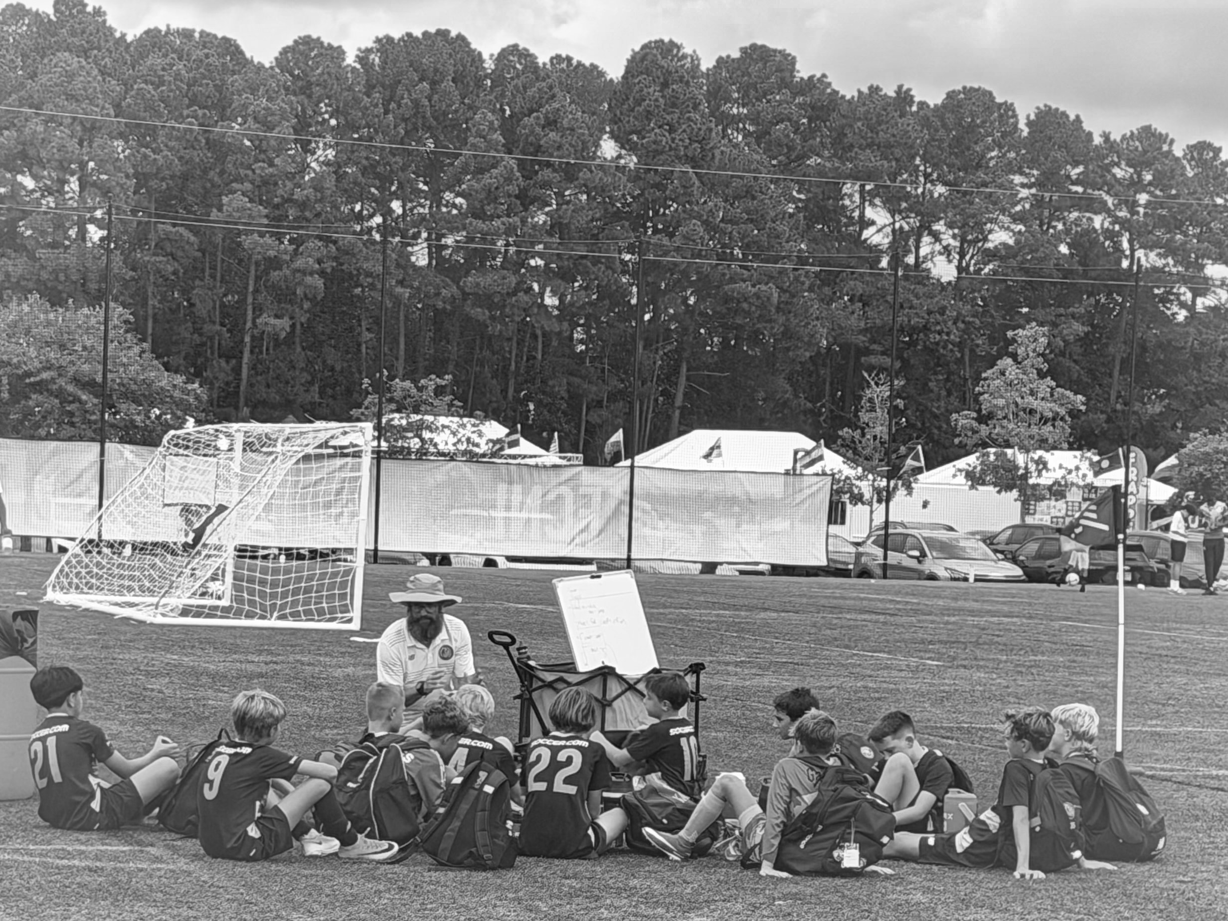 Coach drawing up plays during team huddle