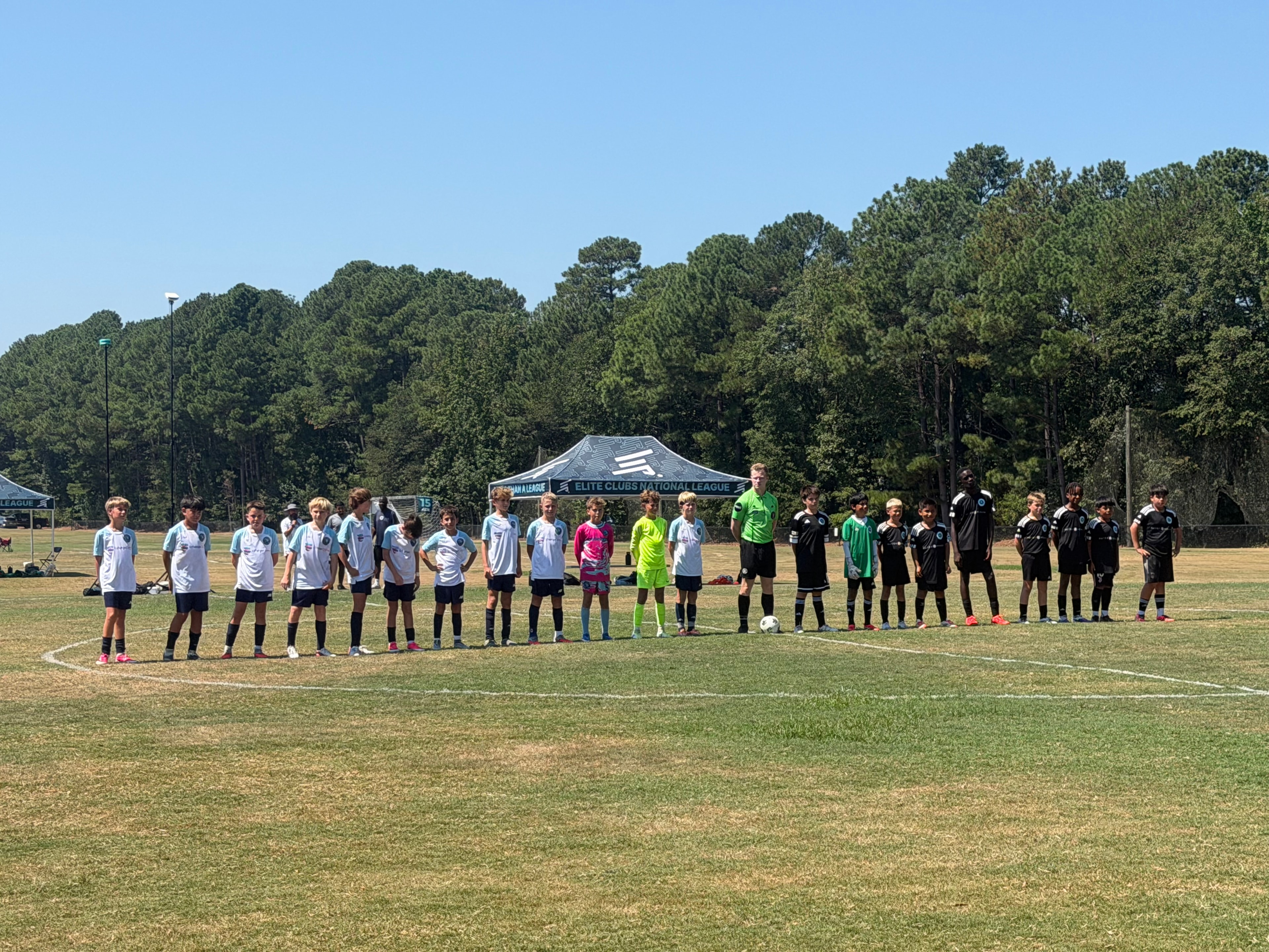 Teams lined up on field before match