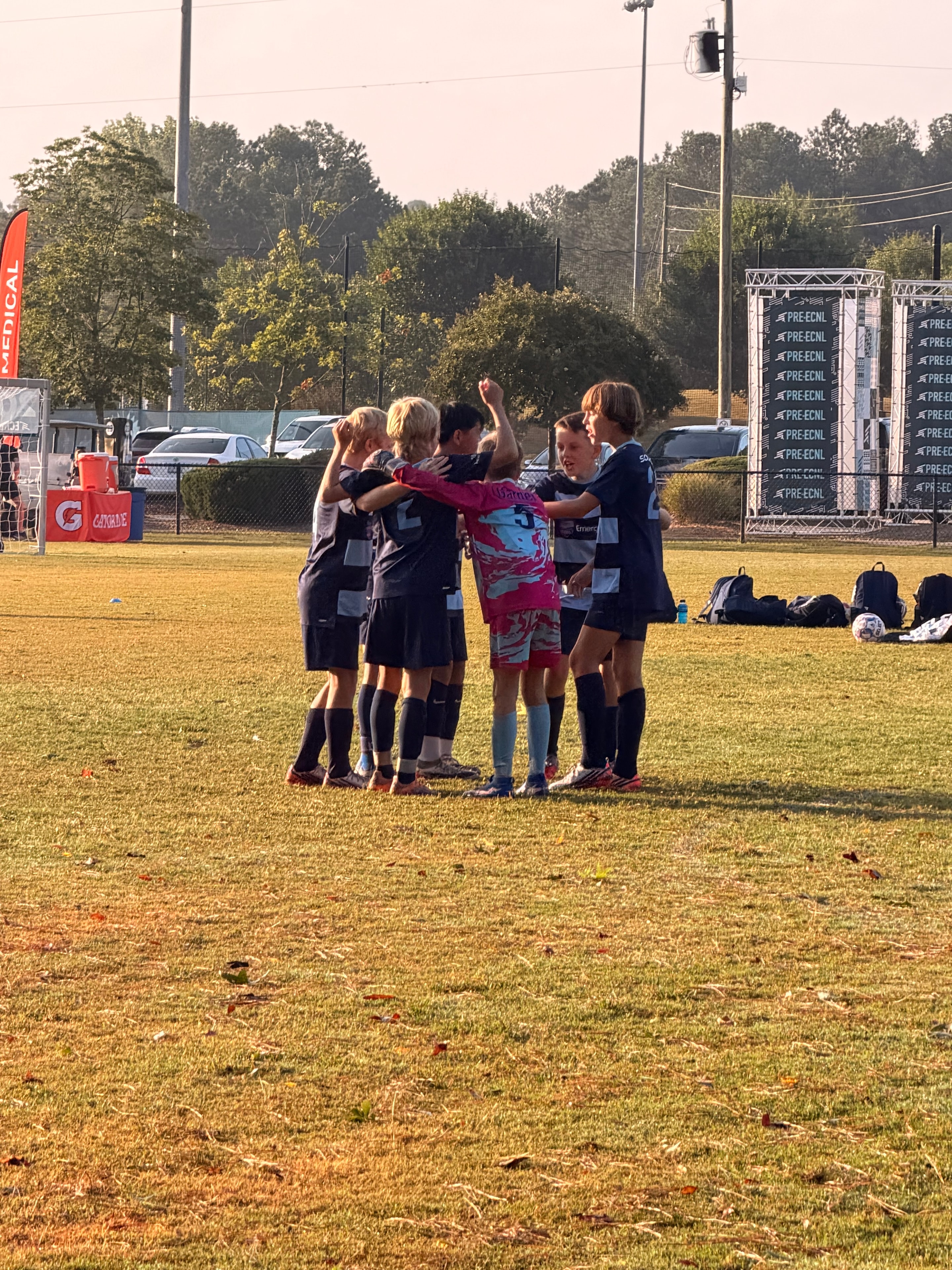 Players in a huddle on the field